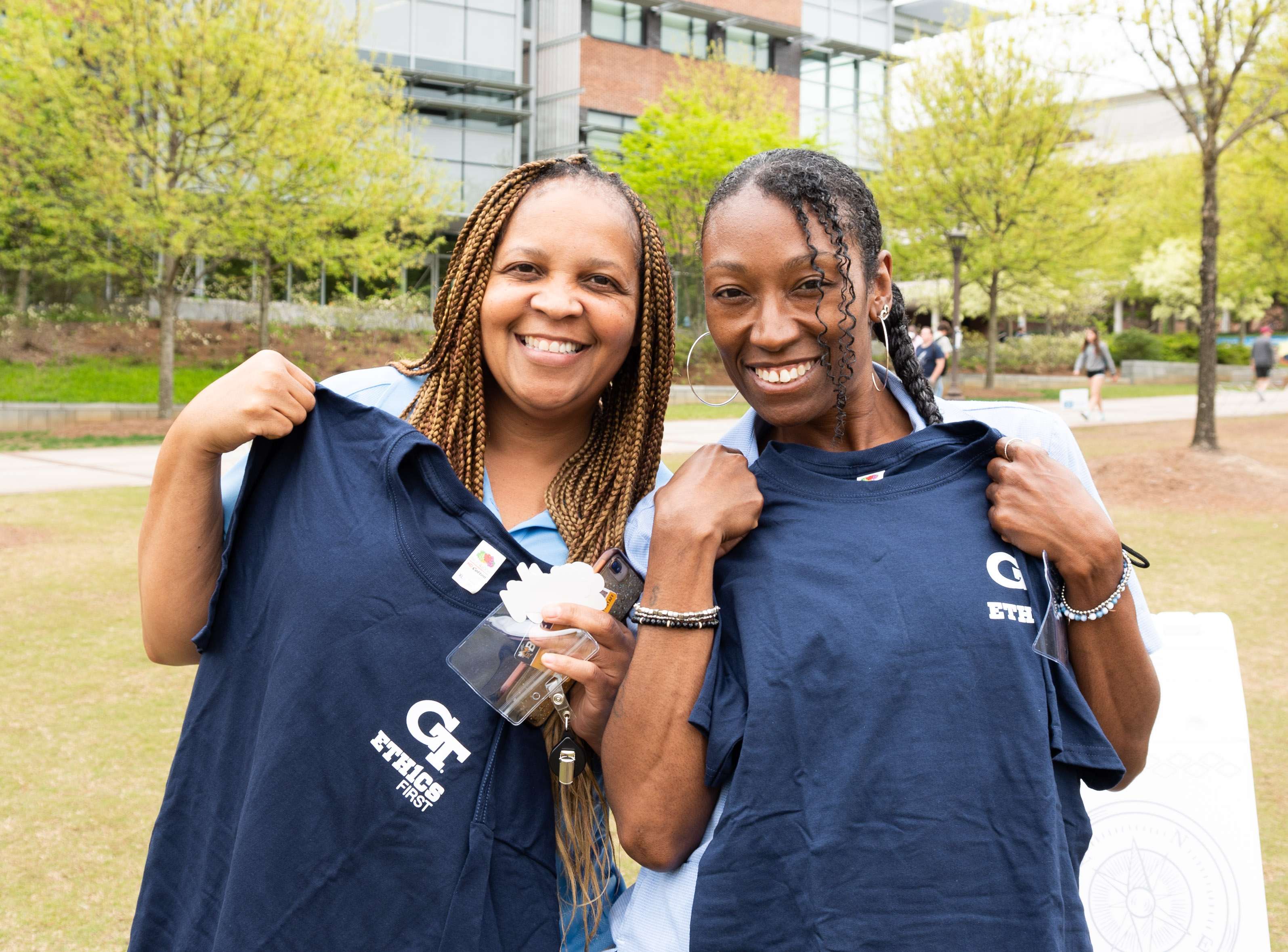 Georgia Tech staff holding georgia tech t-shirts