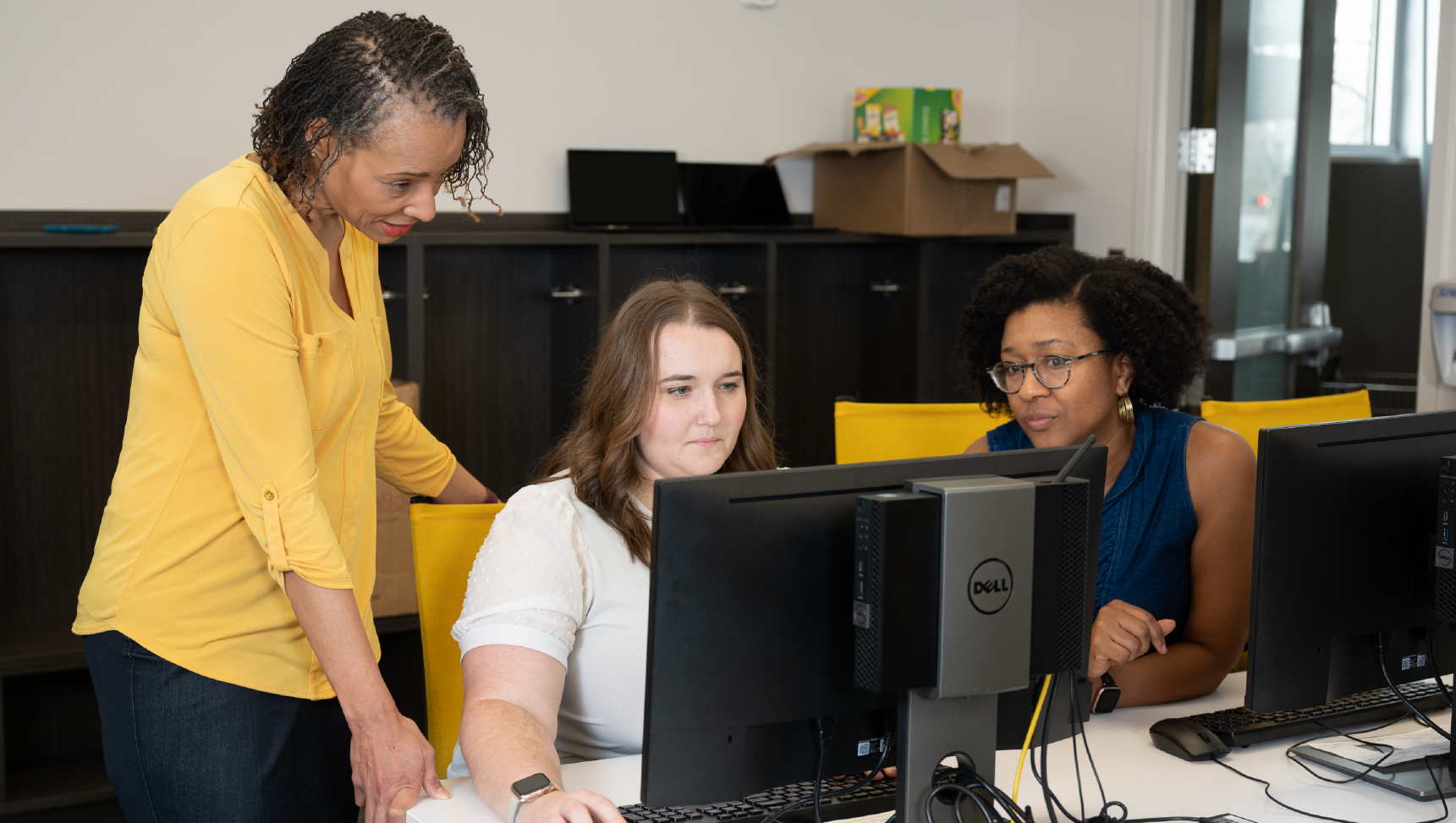 3 staff members in office working together