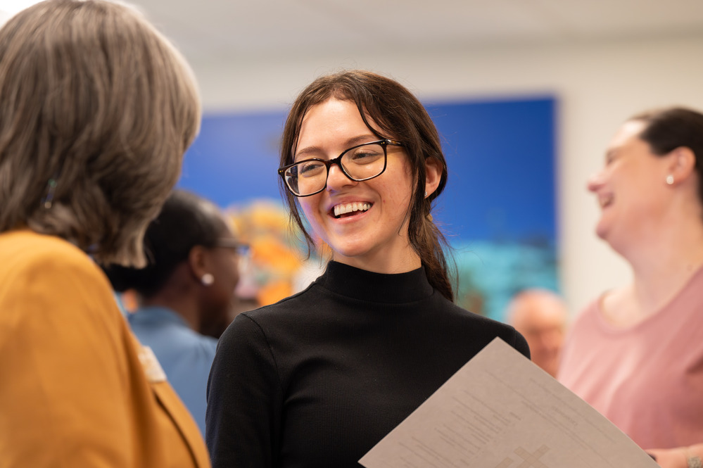 image of staff member smiling while in conversation