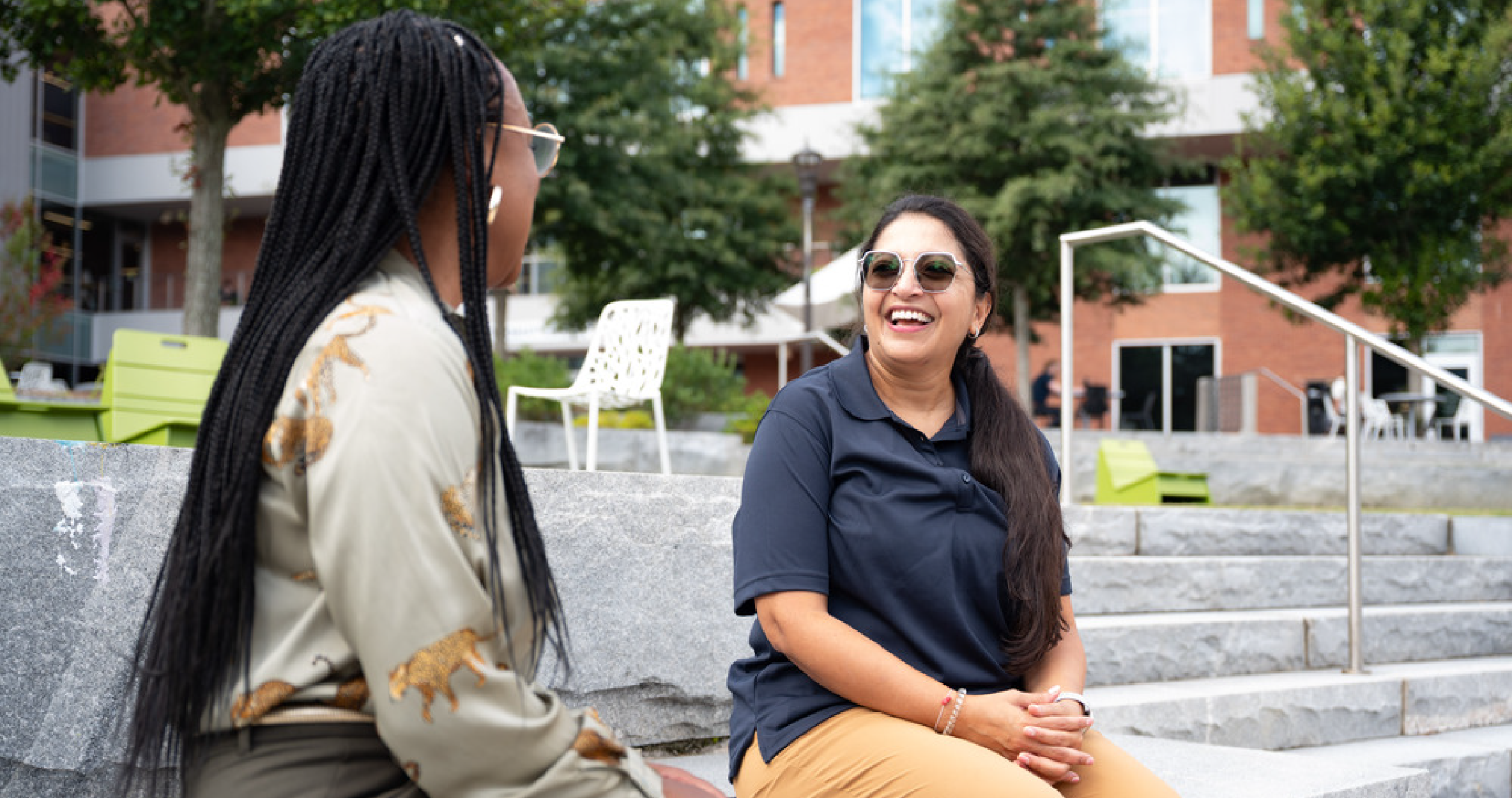 two Tech employees talking outside